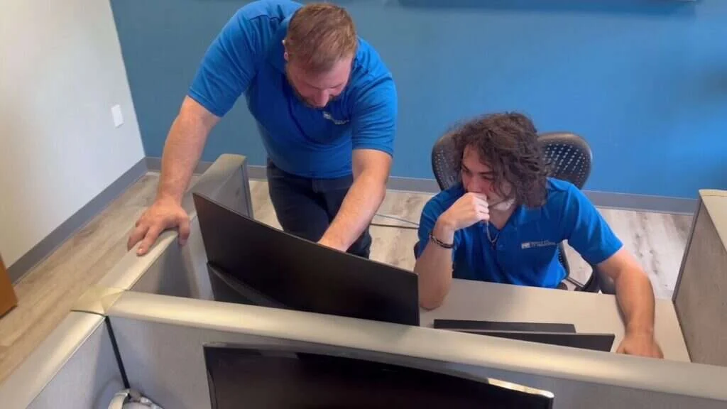 Two Buffalo IT Services technicians working through a client issue together in the office