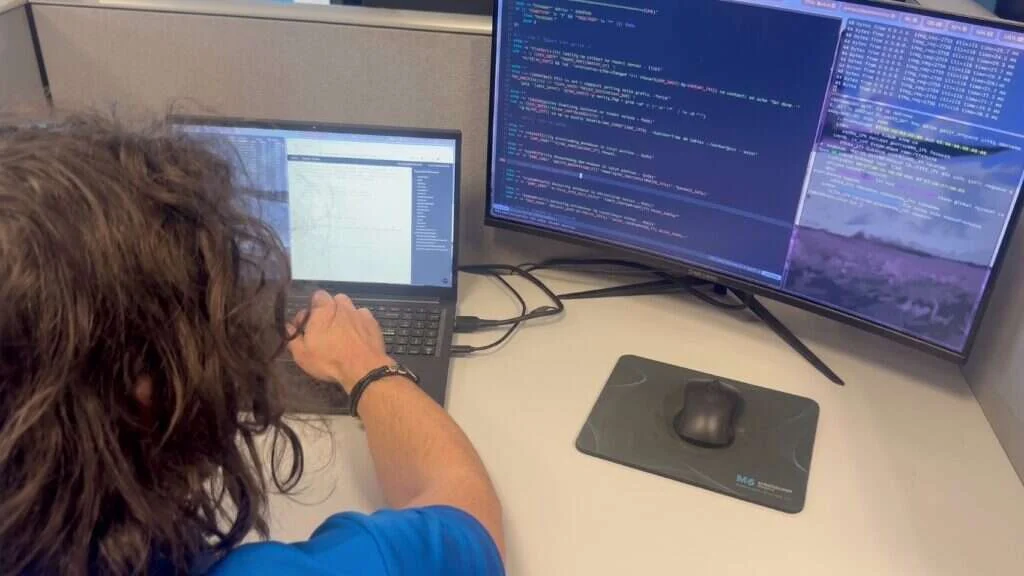Buffalo IT Services network engineer reviewing live network diagnostics on dual monitors